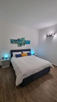 a bedroom with a large bed with blue lights on it at Simply the best - apartment and parking space by Balsamotto in Palermo