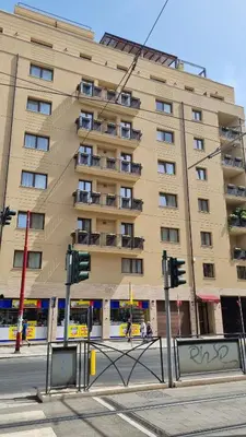 a large apartment building on the corner of a street at Simply the best - apartment and parking space by Balsamotto in Palermo