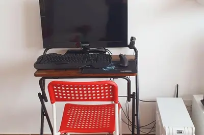 a desk with a computer monitor and a red chair at Simply the best - apartment and parking space by Balsamotto in Palermo