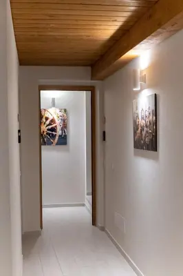 a hallway with two pictures on the walls and a door at Open Sicily Homes - Near the Central Train Station in Palermo
