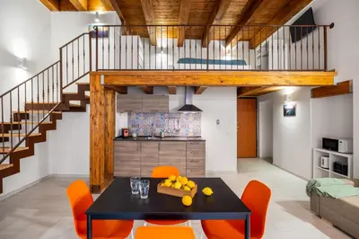 a kitchen and dining room with a table and orange chairs at Open Sicily Homes - Near the Central Train Station in Palermo