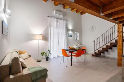 a living room with a couch and a table at Open Sicily Homes - Near the Central Train Station in Palermo