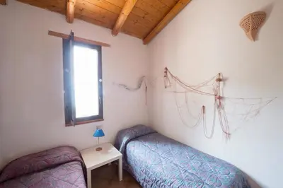 a bedroom with two beds and a window at Terrazza sul mare Scopello in Scopello
