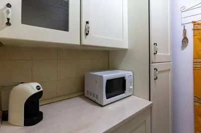 a microwave sitting on a counter in a kitchen at Isola delle Femmine Holiday in Isola delle Femmine