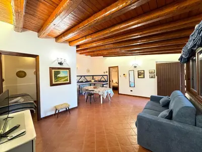 a living room with a blue couch and a table at Villa Talìa in Carini