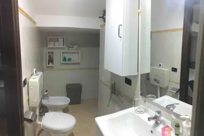 a bathroom with a white toilet and a sink at Alloggio incantevole/ bedsitting-room in Altavilla Milicia