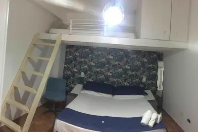 a small bedroom with a bunk bed and a ladder at Alloggio incantevole/ bedsitting-room in Altavilla Milicia