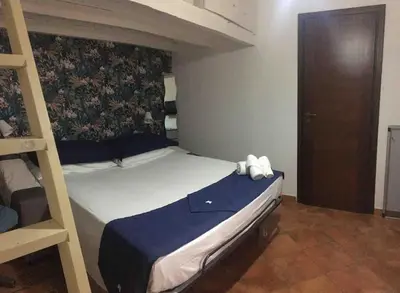 a bedroom with a bunk bed and a ladder at Alloggio incantevole/ bedsitting-room in Altavilla Milicia