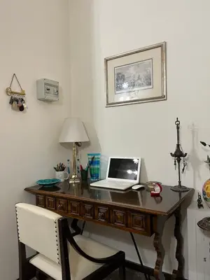 a desk with a laptop computer on top of it at Holiday & House - Imparato Palermo Centro Politeama in Palermo