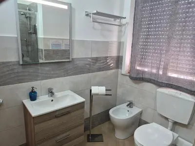 a shower with a glass door in a bathroom at SUITE PRINCIPE SCORDIA in Palermo