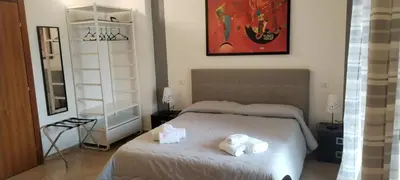 a bedroom with a bed with two towels on it at SUITE PRINCIPE SCORDIA in Palermo