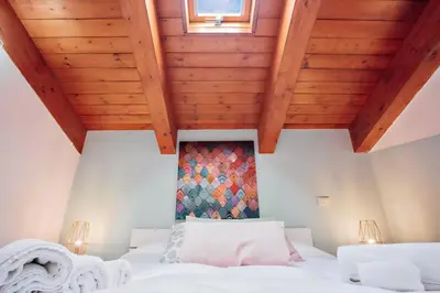 a bedroom with a large bed with wooden ceilings at Happie Casa La Cattedrale in Palermo