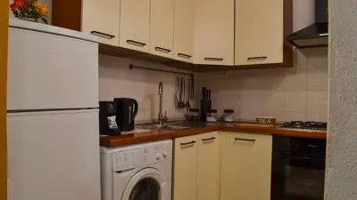 a kitchen with a white refrigerator and a dishwasher at Happie Casa La Cattedrale in Palermo