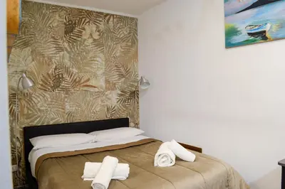 a bedroom with a bed with towels on it at Happie Casa La Cattedrale in Palermo