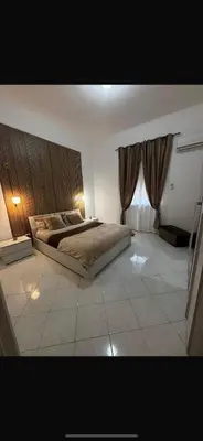 a bedroom with a large bed and a window at Casa Leila in Palermo
