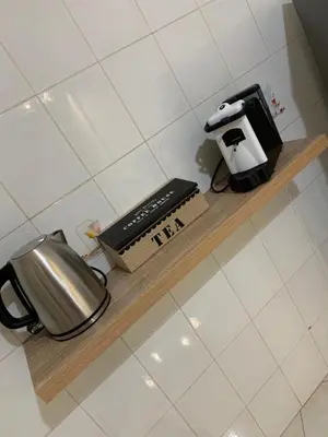 a counter top with a coffee maker and a tea kettle at Casa Leila in Palermo