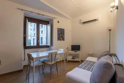 a living room with a table and chairs and a couch at Borsa Apartments by Wonderful Italy in Palermo