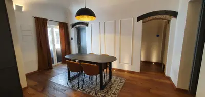 a dining room with a black table and chairs at Gioiamia - Luxury Rooms in Cattedrale in Palermo