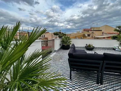 a balcony with two couches on a roof at Gioiamia - Luxury Rooms in Cattedrale in Palermo