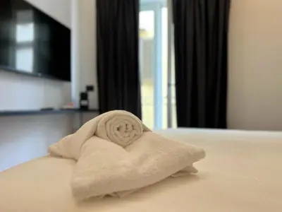 a towel in the shape of a heart on a bed at Gioiamia - Luxury Rooms in Cattedrale in Palermo