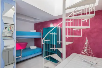 a room with bunk beds and a ladder at Cambusa del Capitano in San Vito lo Capo