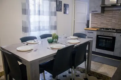 a table in a kitchen with chairs and a table at Pacini Deluxe Apartment in Palermo