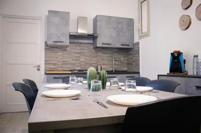 a kitchen with a table with plates and glasses on it at Pacini Deluxe Apartment in Palermo