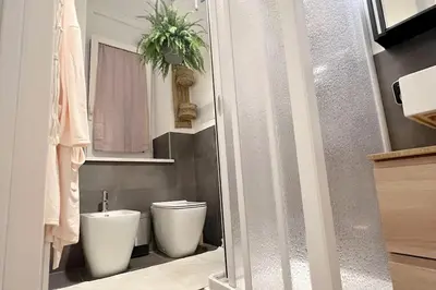 a bathroom with a white toilet and a sink at Carducci apartment in Palermo