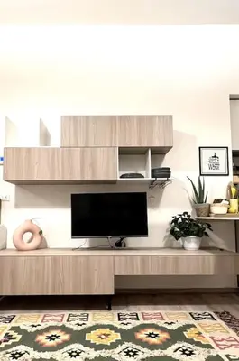 a living room with a flat screen tv on a entertainment center at Carducci apartment in Palermo