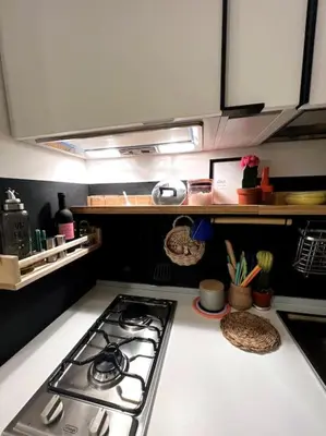 a kitchen with a stove and a white counter top at Carducci apartment in Palermo