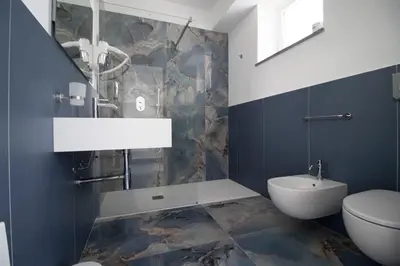 a bathroom with a toilet and a bidet and a sink at Hotel Arte Mare in San Vito lo Capo
