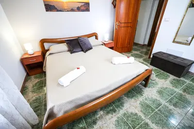 a bedroom with a bed with two towels on it at B&B Giardino dei Cedri in Trabia