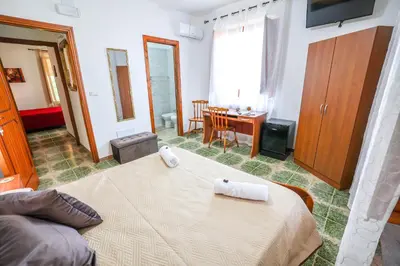 a bedroom with a bed with two towels on it at B&B Giardino dei Cedri in Trabia