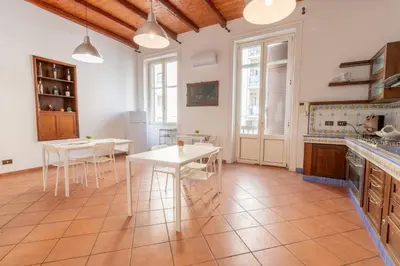 a kitchen with white tables and white chairs at MARIANO APARTMENT Palermo in Palermo