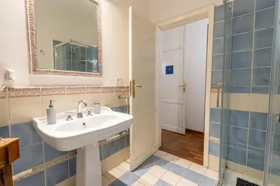 a bathroom with a sink and a mirror and a shower at MARIANO APARTMENT Palermo in Palermo