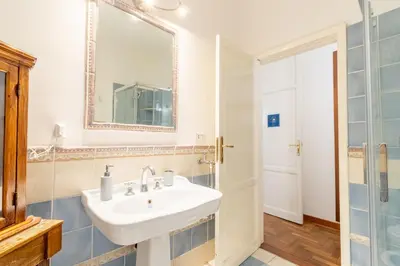 a bathroom with a sink and a mirror at MARIANO APARTMENT Palermo in Palermo
