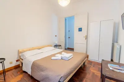 a bedroom with a bed with two towels on it at MARIANO APARTMENT Palermo in Palermo