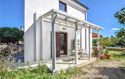 a small white house with a table and chairs at Gorgeous Home In Trabia With Wifi in Trabia