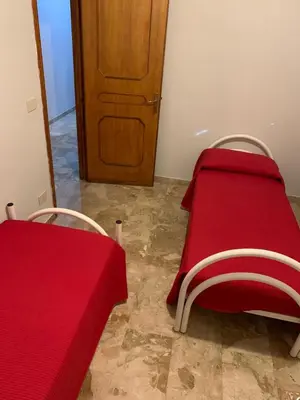 a red table and chairs with a red table cloth at D'Kasa Mia Capaci in Capaci
