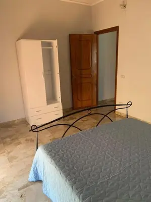 a bedroom with a bed and a dresser and a mirror at D'Kasa Mia Capaci in Capaci