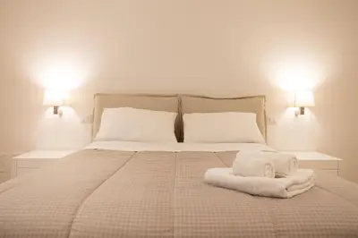 a bedroom with a bed with two towels on it at Luxury Libertà in Palermo