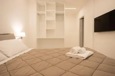 a bedroom with a large bed with towels on it at Luxury Libertà in Palermo