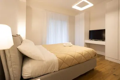 a bedroom with a bed and a flat screen tv at Luxury Libertà in Palermo