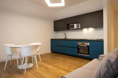 a kitchen with a table and chairs in a room at Luxury Libertà in Palermo