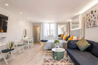a living room with a couch and a table at ROCCA POLITEAMA Attico Prestigioso ed Eccitante. in Palermo