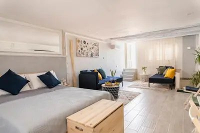 a bedroom with a bed and a living room at ROCCA POLITEAMA Attico Prestigioso ed Eccitante. in Palermo