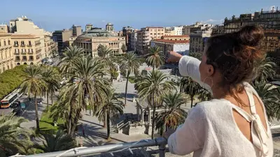 a woman taking a picture of a city at ROCCA POLITEAMA Attico Prestigioso ed Eccitante. in Palermo