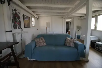 a blue couch sitting in a living room at Stunning Kalsa in Palermo