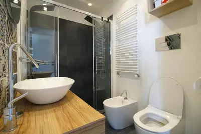 a bathroom with a sink and a toilet and a shower at Stunning Kalsa in Palermo