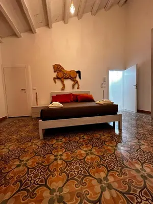 a bedroom with a bed with a lion statue on the wall at LB Home in Termini Imerese